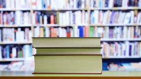 Book,table and person hand leave one book at library. - Powered by Shutterstock - Get 15% off with code: PIKWIZARD15