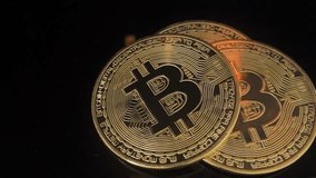 Close-up view of three gold Bitcoin coins illuminated by warm golden lighting against a blurred circuit board background, representing cryptocurrency, blockchain technology, and modern digital finance - Powered by Shutterstock - Get 15% off with code: PIKWIZARD15