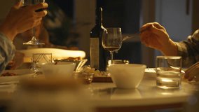 Romantic family dinner. Young married couple sitting at table in evening eating Italian pasta spaghetti drinking wine. Married couple with child having dinner at home in evening - Powered by Shutterstock - Get 15% off with code: PIKWIZARD15