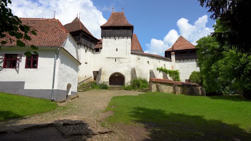 The Viscri fortified church, Lutheran church in Viscri, Brașov County,  Transylvania region of Romania. It was built by the ethnic German Transylvanian Saxon. UNESCO World Heritage. Panning right