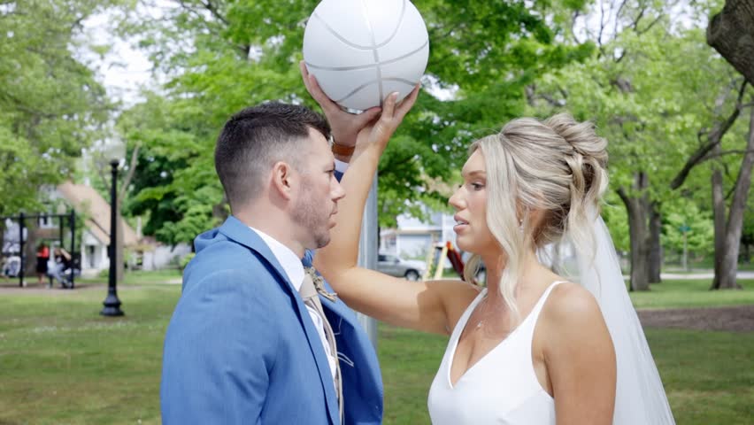 Bride and groom pose and kiss sporty like