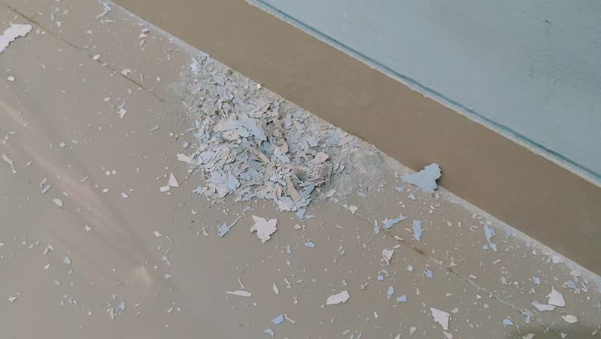 4K video of a hand gripping peeled-off wall paint flakes during a home renovation, showing brittle texture, chipped layers, and surface deterioration before repainting and restoration work
 - Powered by Shutterstock - Get 15% off with code: PIKWIZARD15