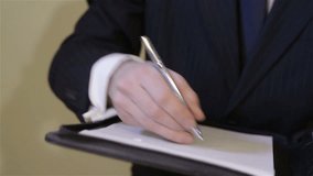 Businessman writing and signing a contract