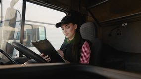 Female truck driver reviewing paperwork in right-hand drive truck before trip - Powered by Shutterstock - Get 15% off with code: PIKWIZARD15