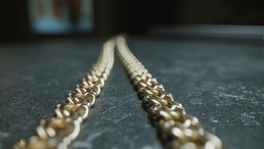Weaving a gold chain lying on the table