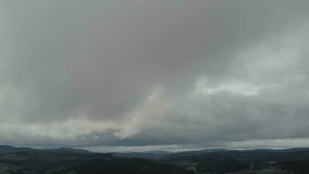 Aerial View Of Majestic Mountains And Lush Forest Under Dark Clouds. A Stunning Rainbow Appears After The Rain As The Drone Soars Through Misty Clouds, Revealing A Breathtaking Scene. - Powered by Shutterstock - Get 15% off with code: PIKWIZARD15