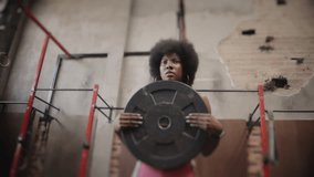 African American model athlete training in the gym sweating happy fighting training with weights skipping rope - Powered by Shutterstock - Get 15% off with code: PIKWIZARD15