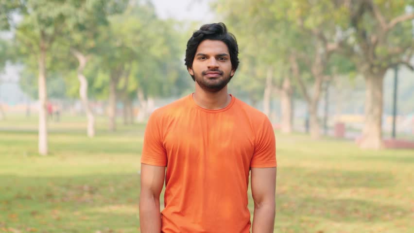 Relaxed Happy Indian Man in Orange T-shirt 