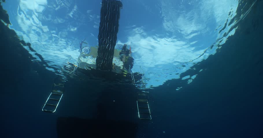 boat underwater scuba diver jumps into water ocean scenery