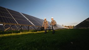 Workers Walk Through Solar Station Carrying Tools - Powered by Shutterstock - Get 15% off with code: PIKWIZARD15