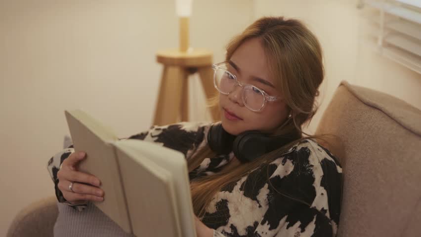 young woman reading book at home, relaxation and leisure