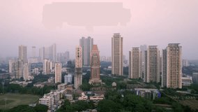 Drone aerial long shot of developing Indian modern cityscape with tall commercial and residential skyscrapers or high rise buildings surrounded by green tree cover. Sustainable infrastructure concept - Powered by Shutterstock - Get 15% off with code: PIKWIZARD15
