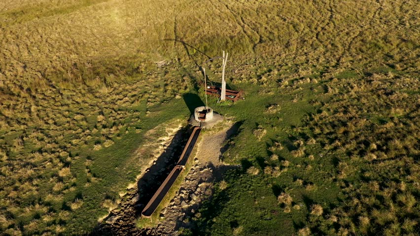 Aerial view of countryside shadoof well in meadow pasture by drone