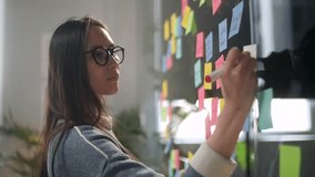 Asian Business Woman Write Tasks Creative Ideas On Sticky Notes On Glass Board, Female Corporate Leader Planning Project On Post It Sticky Notes Organize Work On Stickers - Powered by Shutterstock - Get 15% off with code: PIKWIZARD15