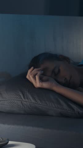 Woman suffering from insomnia in her bed