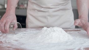 A cook scoops flour into a measuring cup. A professional baker prepares dough for bread or dessert and pizza. Slow motion. - Powered by Shutterstock - Get 15% off with code: PIKWIZARD15