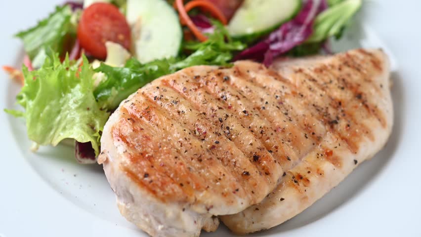  Healthy grilled chicken with salad on white plate