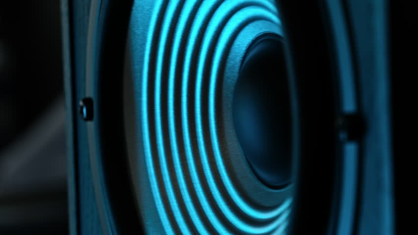 Bass Speaker Vibrating To Music Under Blue Light