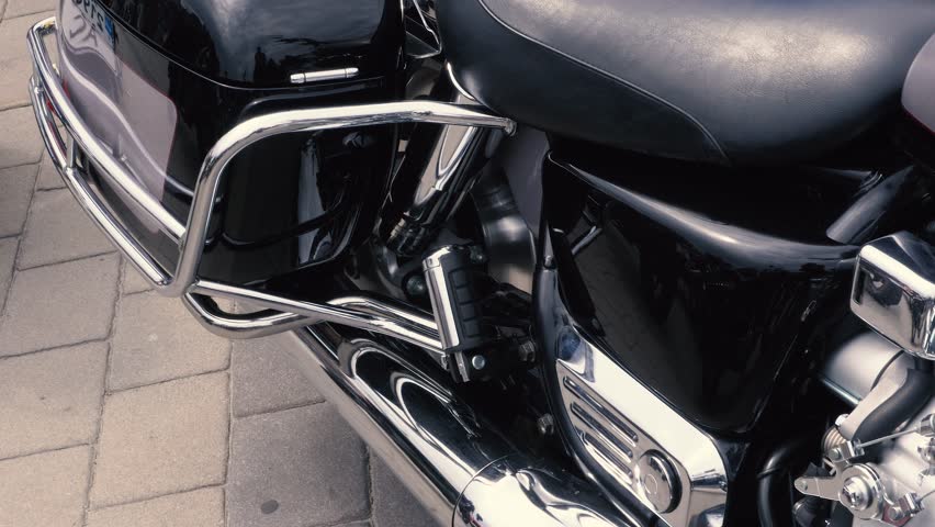 Vintage shabby scooter or mini motorcycle stands outdoors. Popular mode of transport. The steering wheel of an old blue moped with a brown seat.