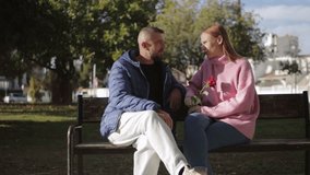 Loving couple walking in sunlit park, intertwining fingers, sharing tender moments with vibrant red rose symbolizing romantic connection.Celebrating valentine's day or anniversary - Powered by Shutterstock - Get 15% off with code: PIKWIZARD15
