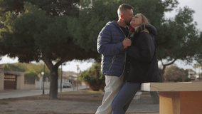 Romantic couple sharing intimate valentine's moment, exchanging tender gestures with red rose in peaceful park setting, symbolizing deep emotional bond.Celebrating valentine's day or anniversary - Powered by Shutterstock - Get 15% off with code: PIKWIZARD15