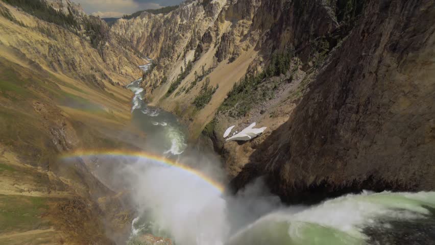 Rainbow over the waterfall. Amazing mountain landscape. Big waterfall among the beautiful rocks. Brink of the Lower Falls on the Grand Canyon of the Yellowstone, Yellowstone National Park, Wyoming.