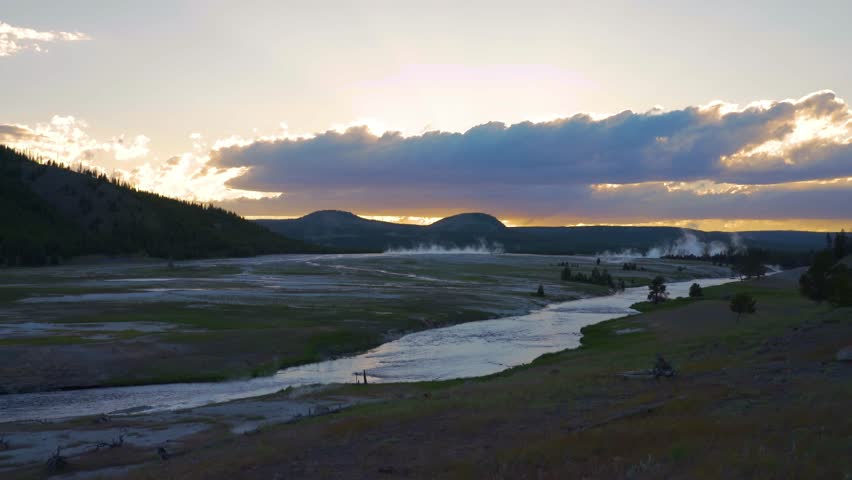 shot of smoke over hot spring at national park against sky during sunset - Yellowstone National Park, Wyoming.