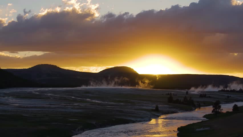 shot of mammatus clouds over geyser against sky during sunset - Yellowstone National Park, Wyoming.