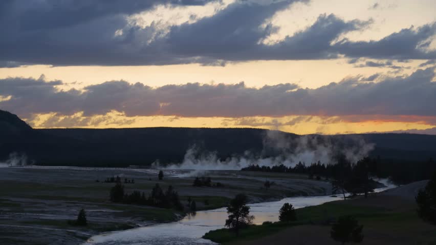 shot of mammatus clouds over geyser against sky during sunset - Yellowstone National Park, Wyoming.