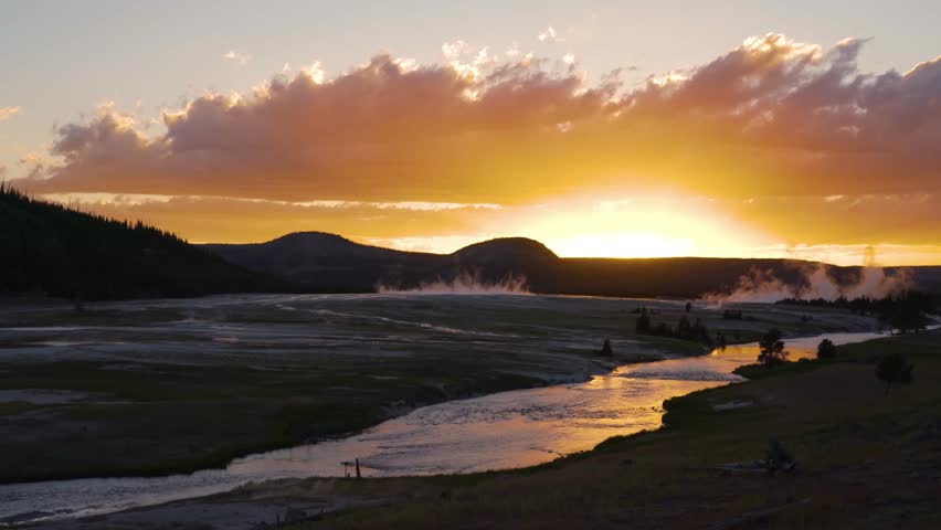 shot of smoke over hot spring at national park against sky during sunset - Yellowstone National Park, Wyoming.