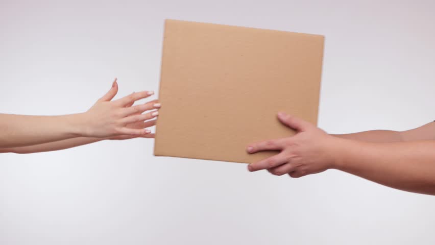 A young beautiful girl in a red T-shirt and a red cap delivers a parcel to a home.