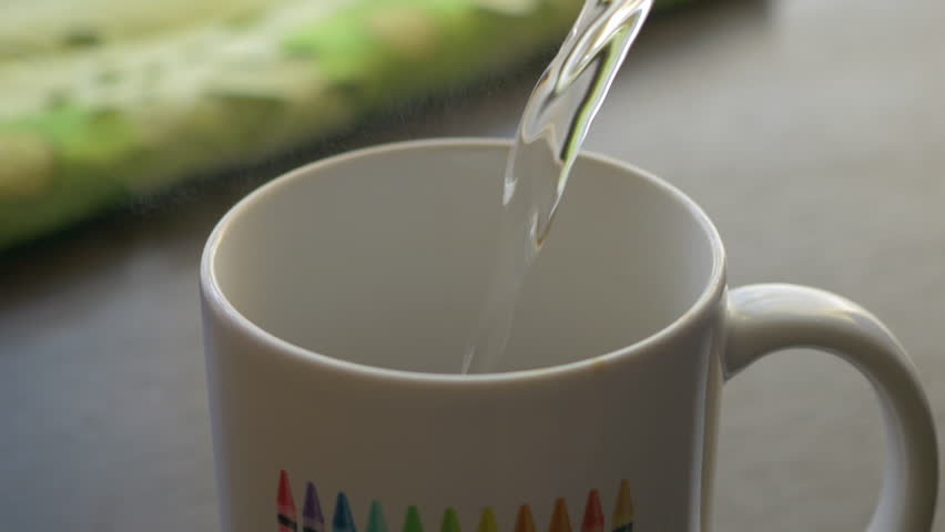 Fresh Morning Pour Over Coffee Close Up. Slow Motion. Milk Chocolate In White Cup. Pouring Hot Water From Kettle to Make Coffee Closeup. Pouring Hot Water Into White Cup Chocolate.