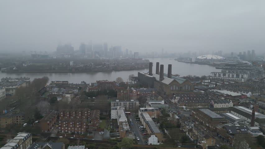 Aerial drone footage of Central London on a foggy day.