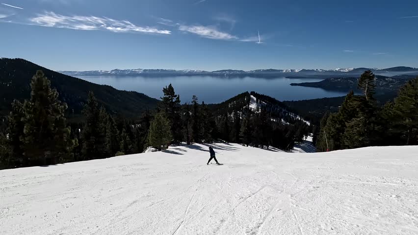 Ski In Lake Tahoe; 4K Action Shot Of Youth Skiing Downhill With Breathtaking Views Of The Lake, Forest, And Mountains.