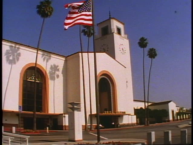 Union Station in Los Angeles, wide shot, Spanish Mission Architecture, flag waving in the breeze