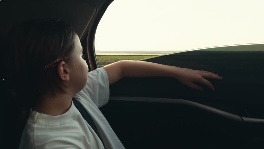 girl child kid rides car back seat catching wind hand, traveling car road, childhood transport, schoolgirl goes school rural road, child kid travels family car road, hand window, girl child kid rides