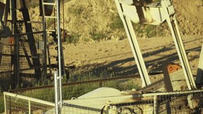Oil derrick pumpjack mechanism operating, showcasing moving parts and industrial components. - Powered by Shutterstock - Get 15% off with code: PIKWIZARD15