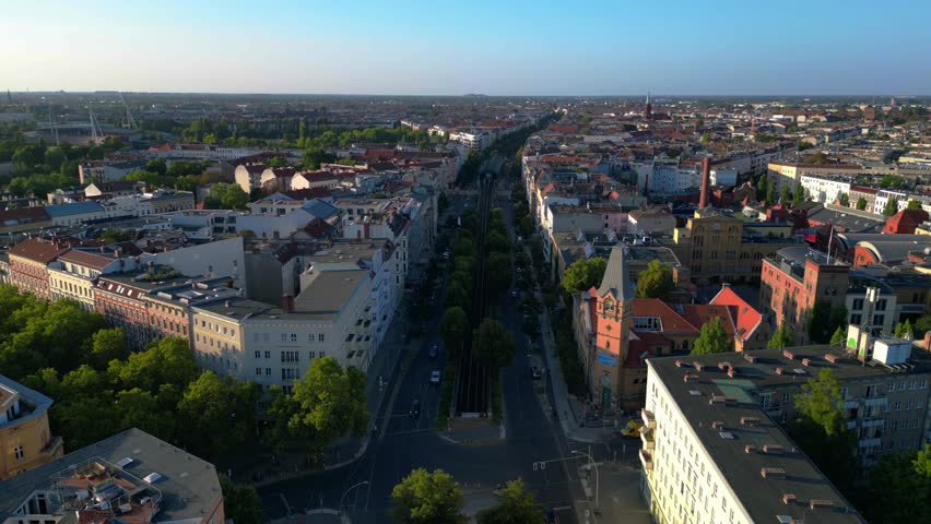 Elevated train navigating through a residential area in berlin, showcasing the city