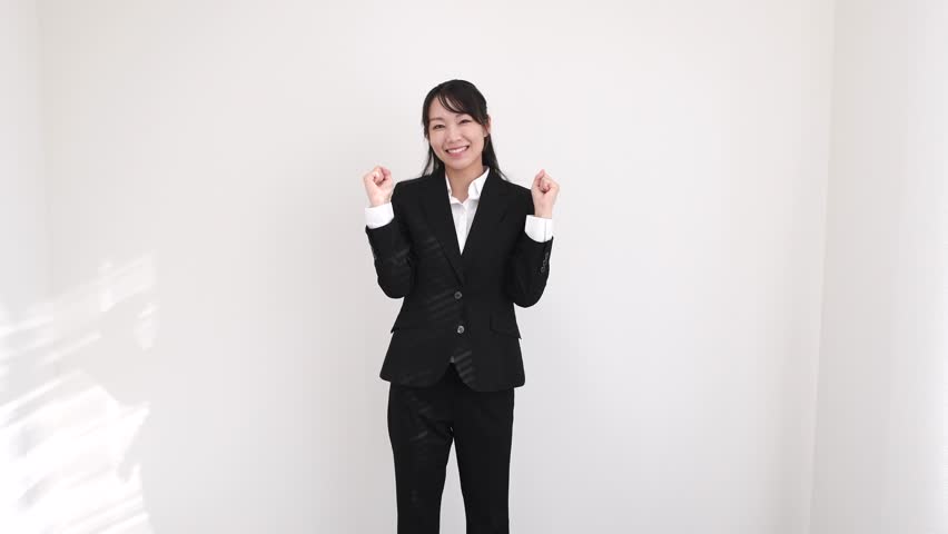 Asian businesswoman in a suit jumping