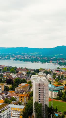 Vertical video. Zurich, Switzerland. Panorama of the city overlooking Lake Zurich. Summer day, Aerial View. Rich colors