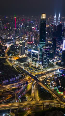 Aerial timelapse of traffic and Kuala Lumpur city skyline at night, Malaysia