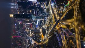 Vertical video. Aerial timelapse of traffic and Kuala Lumpur city skyline at night, Malaysia - Powered by Shutterstock - Get 15% off with code: PIKWIZARD15