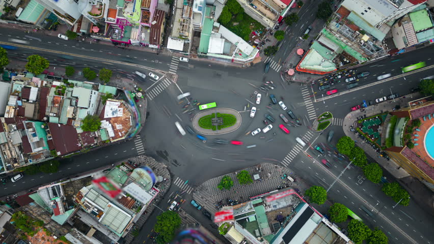 Aerial timelapse of morning traffic at intersection in residential area in Ho Chi Minh City, Vietnam.