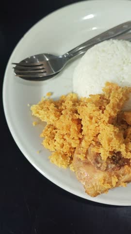 a plate of fried chicken rice 