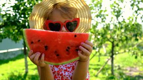 Child in sunglasses eating watermelon in the garden. Selective focus. - Powered by Shutterstock - Get 15% off with code: PIKWIZARD15