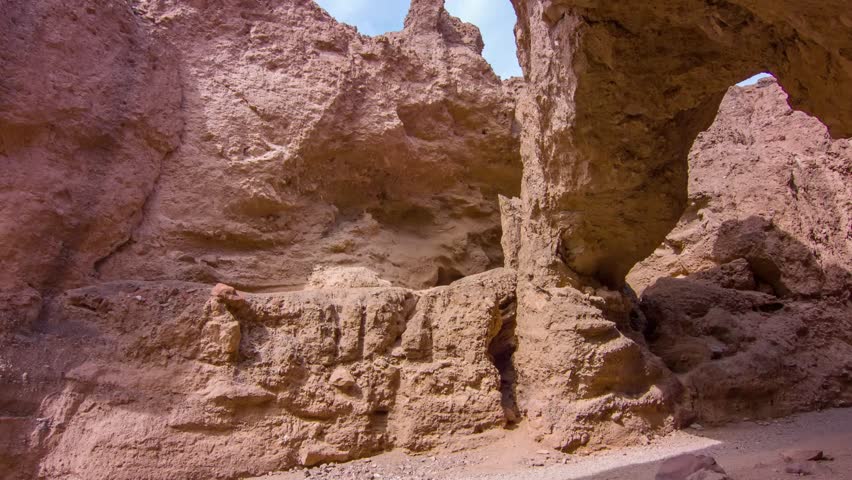 Admire the Natural Bridge stone arch in Death Valley, framed by a clear blue sky, creating a stunning natural landmark for visitors.