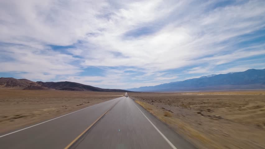 Footage of a vehicle navigating through the remote Canyon Road in Death Valley National Park, California, featuring rocky desert scenery and rugged landscapes, perfect for travel enthusiasts.