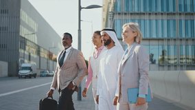 Group of multiethnic business people meeting an emirati businessman - International corporate business team bonding outdoors in the city - Powered by Shutterstock - Get 15% off with code: PIKWIZARD15