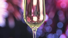 A close-up of a champagne flute filled with sparkling wine, highlighted against fireworks bokeh background. - Powered by Shutterstock - Get 15% off with code: PIKWIZARD15