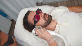 Woman Cosmetologist Performs Beard Edging Procedure with Laser Hair Removal at Beauty Salon. Concept of Body Care and Health. Slow motion. - Powered by Shutterstock - Get 15% off with code: PIKWIZARD15